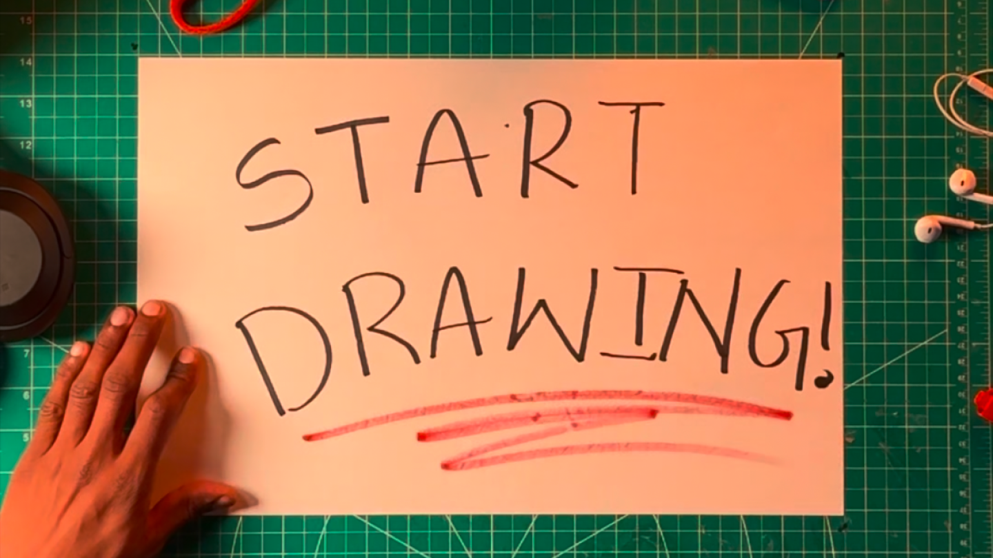 START DRAWING! — hand-written on paper on a cutting mat